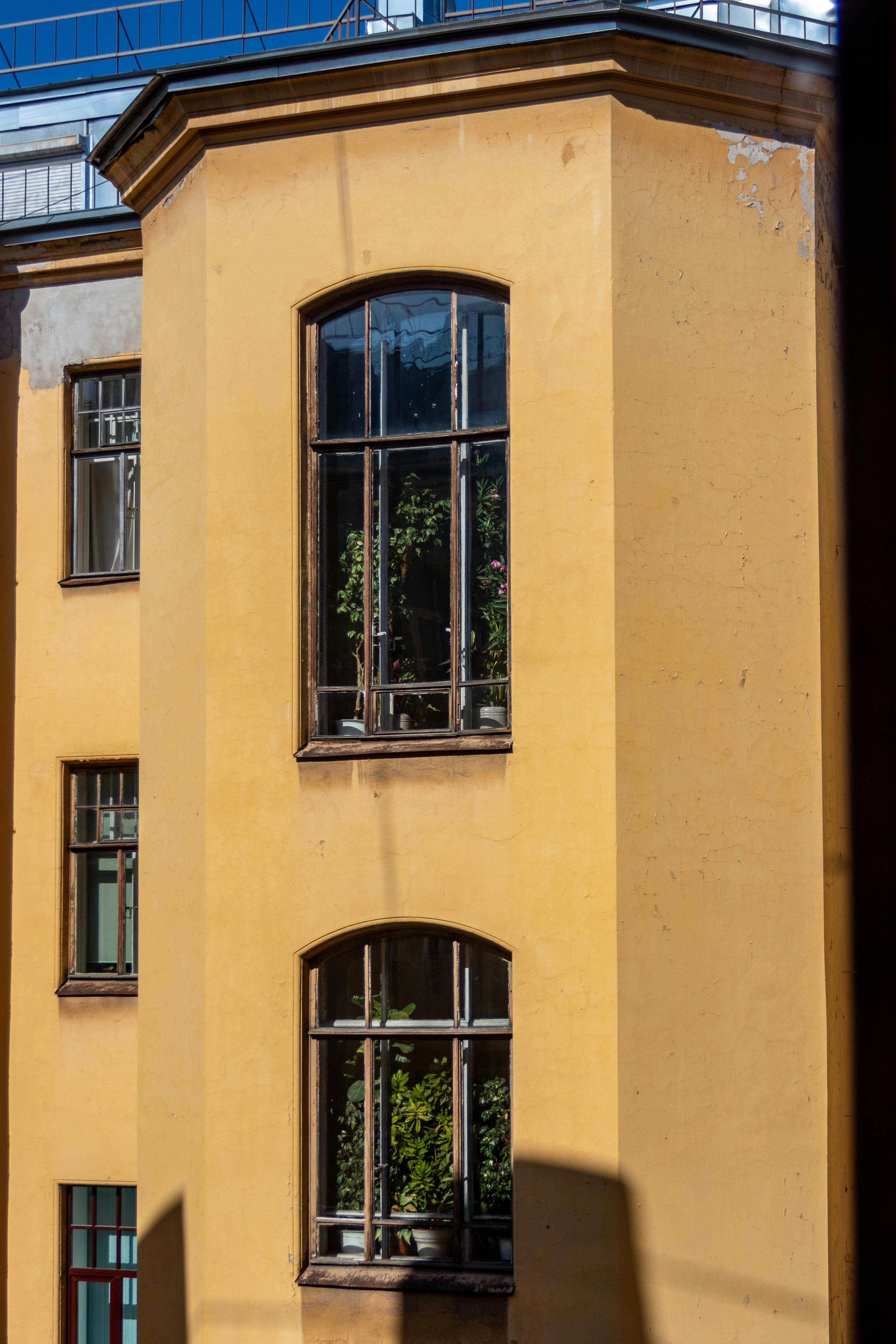 Facade of a Traditional Yellow Residential Building in City · Free