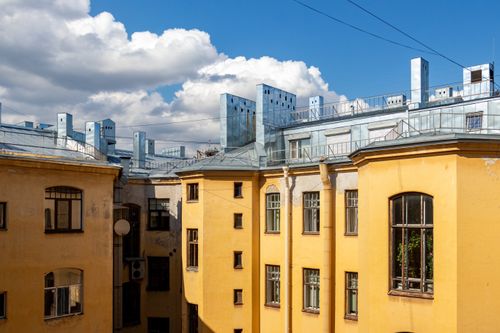 Free Sunlit vintage buildings with blue sky and clouds, highlighting urban architecture. Stock Photo
