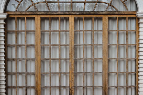 Wooden Frames on Windows and Curtain behind