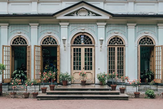 Beautiful facade of a historical building with potted plants, showcasing elegant architecture in Saint Petersburg.