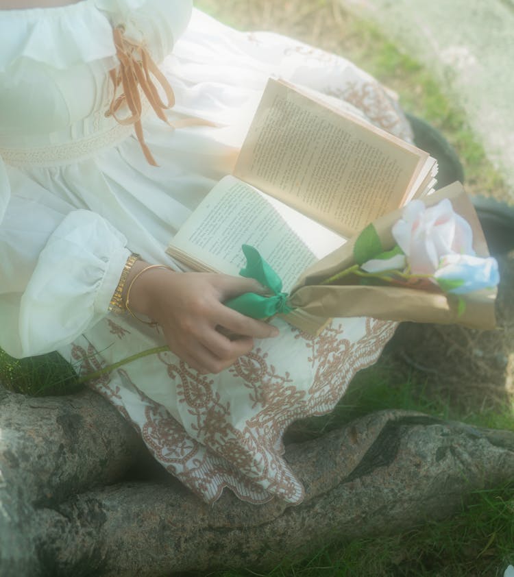 Woman In Embroidered Dress Reading Book