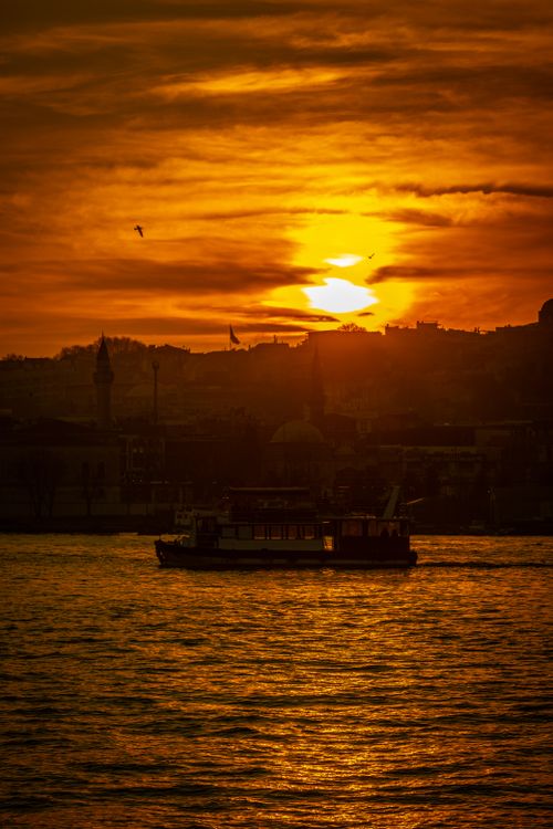 Free Scenic İstanbul sunset with silhouetted boat highlighting the city's skyline. Stock Photo