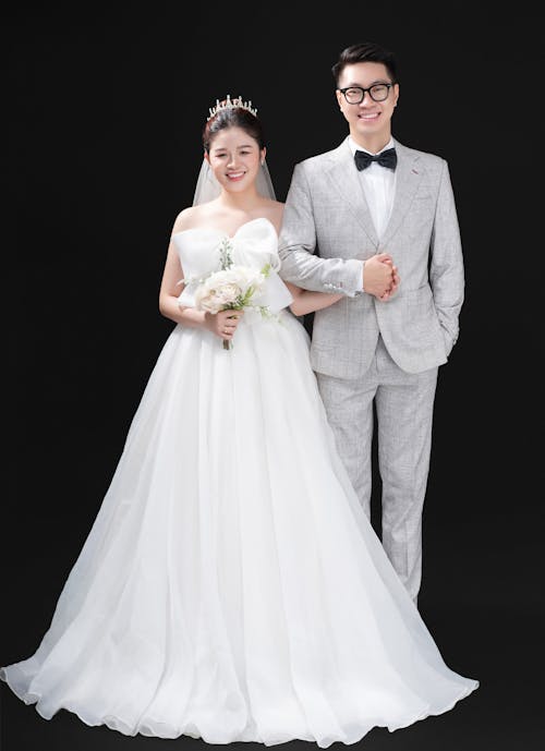 Smiling Woman in Wedding Dress and Man in Suit