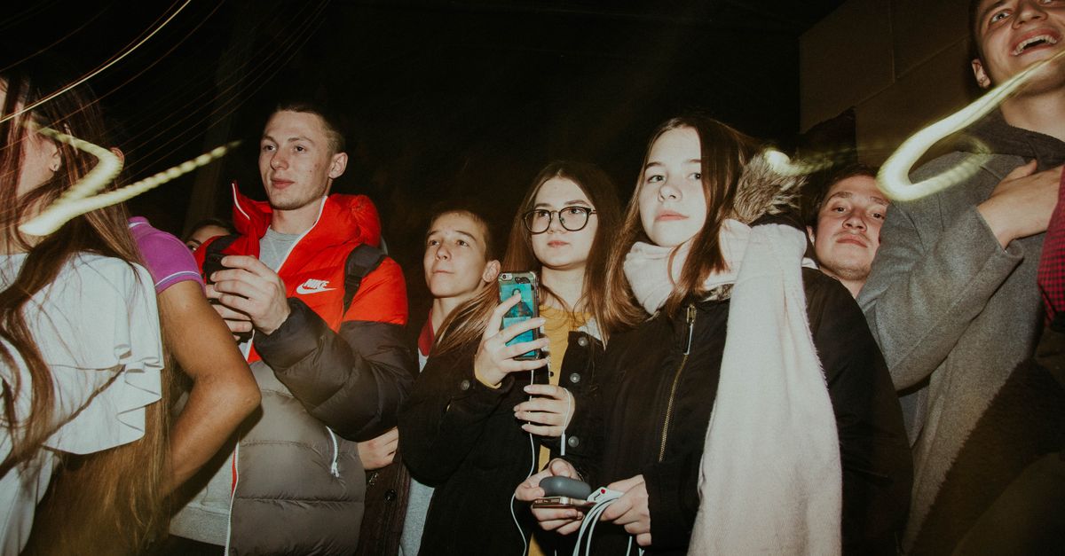 young people having genuine conversation without phones