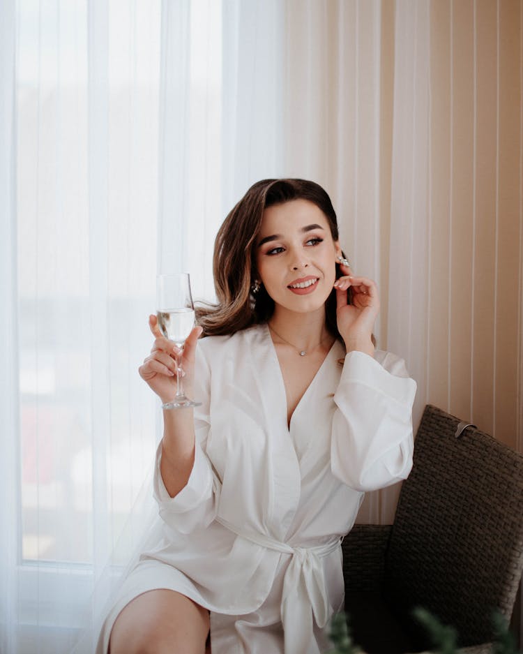 Woman Sitting And Posing With Drink