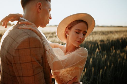 A couple embracing in a sunlit field, depicting love and tranquility.