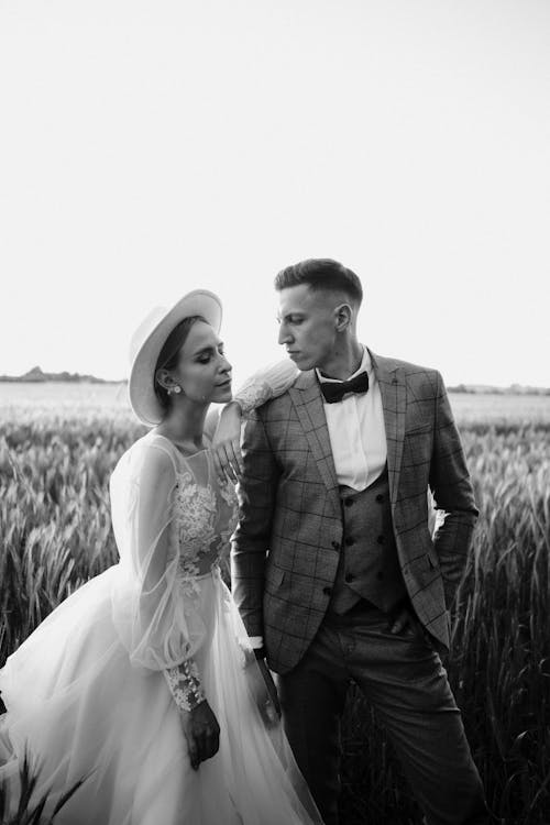 Newlyweds Posing on Field in Black and White
