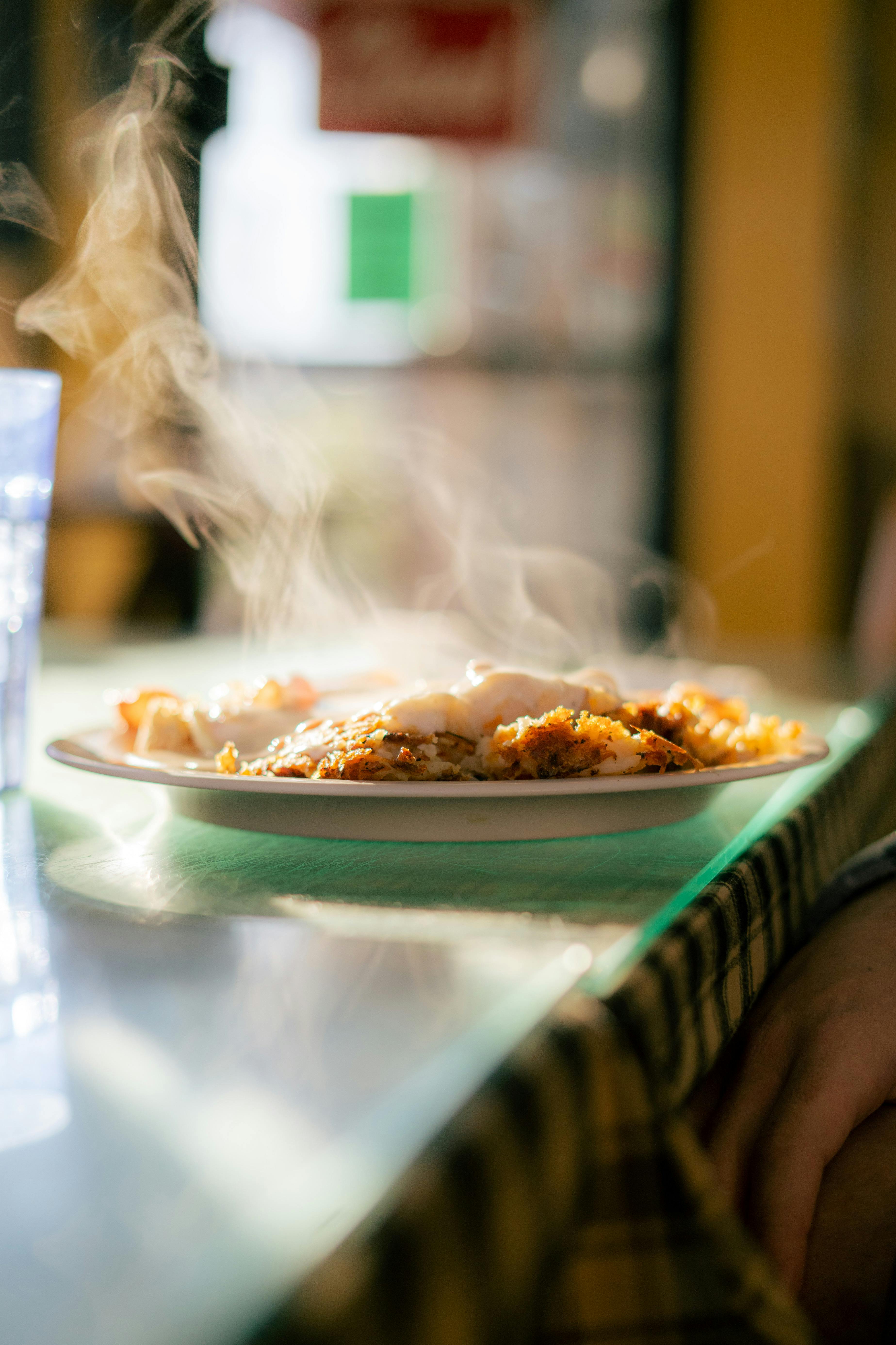 steamy delicious food on plate on table