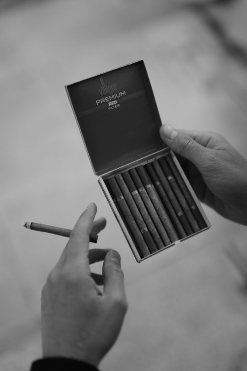 Hand Holding Box of Cigarettes · Free Stock Photo