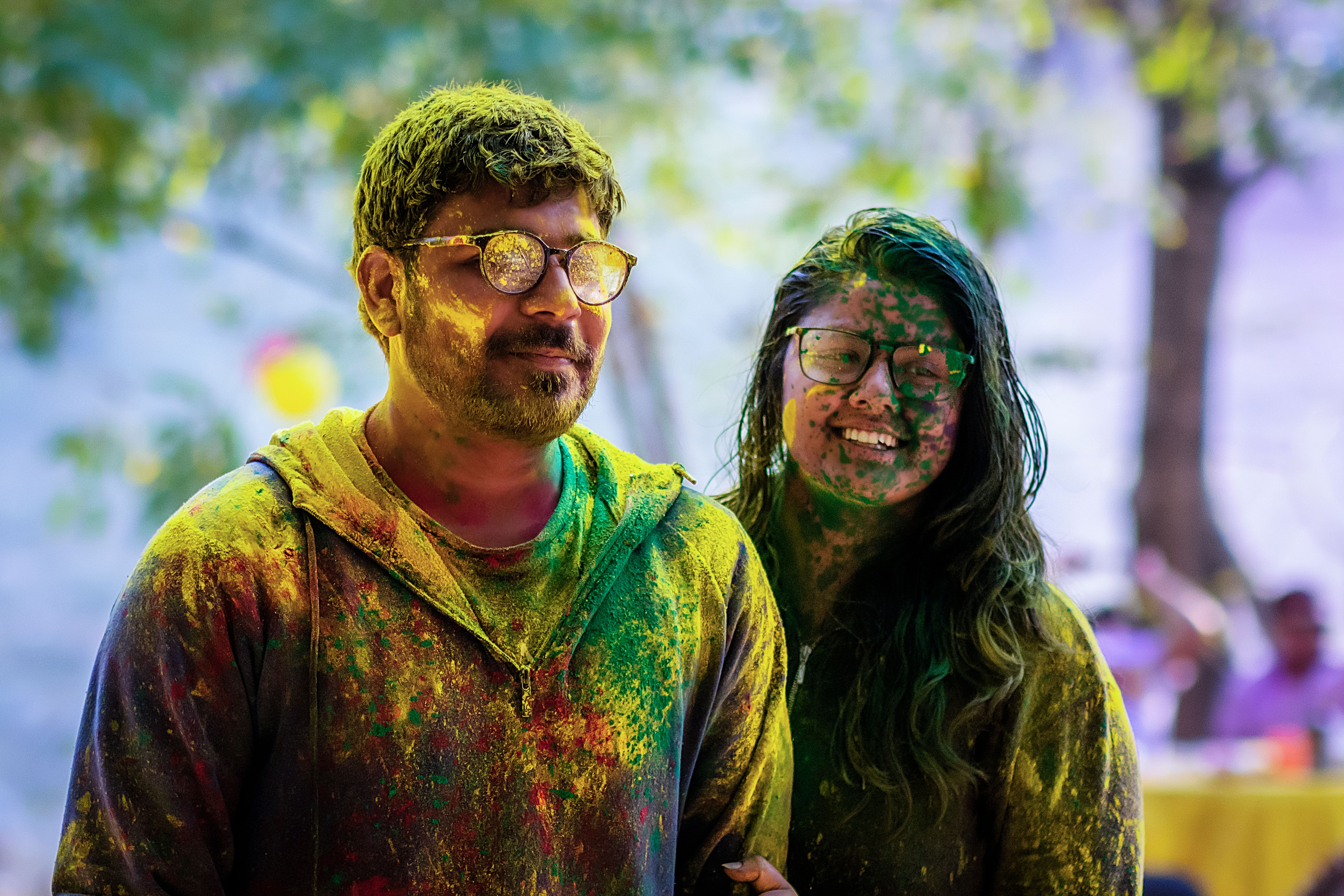 Colorful Powder on Smiling Woman and Man · Free Stock Photo