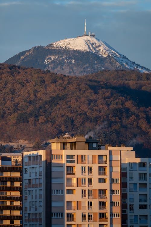 Mountain and Forest behind Building in Town