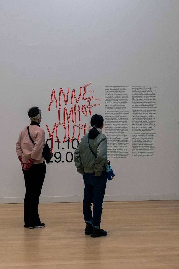 People Looking At Walls In Modern Museum