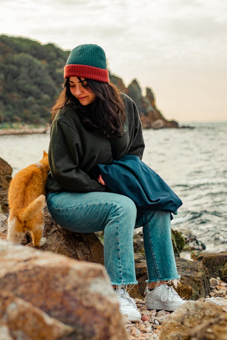 Woman With Ginger Cat At Beach