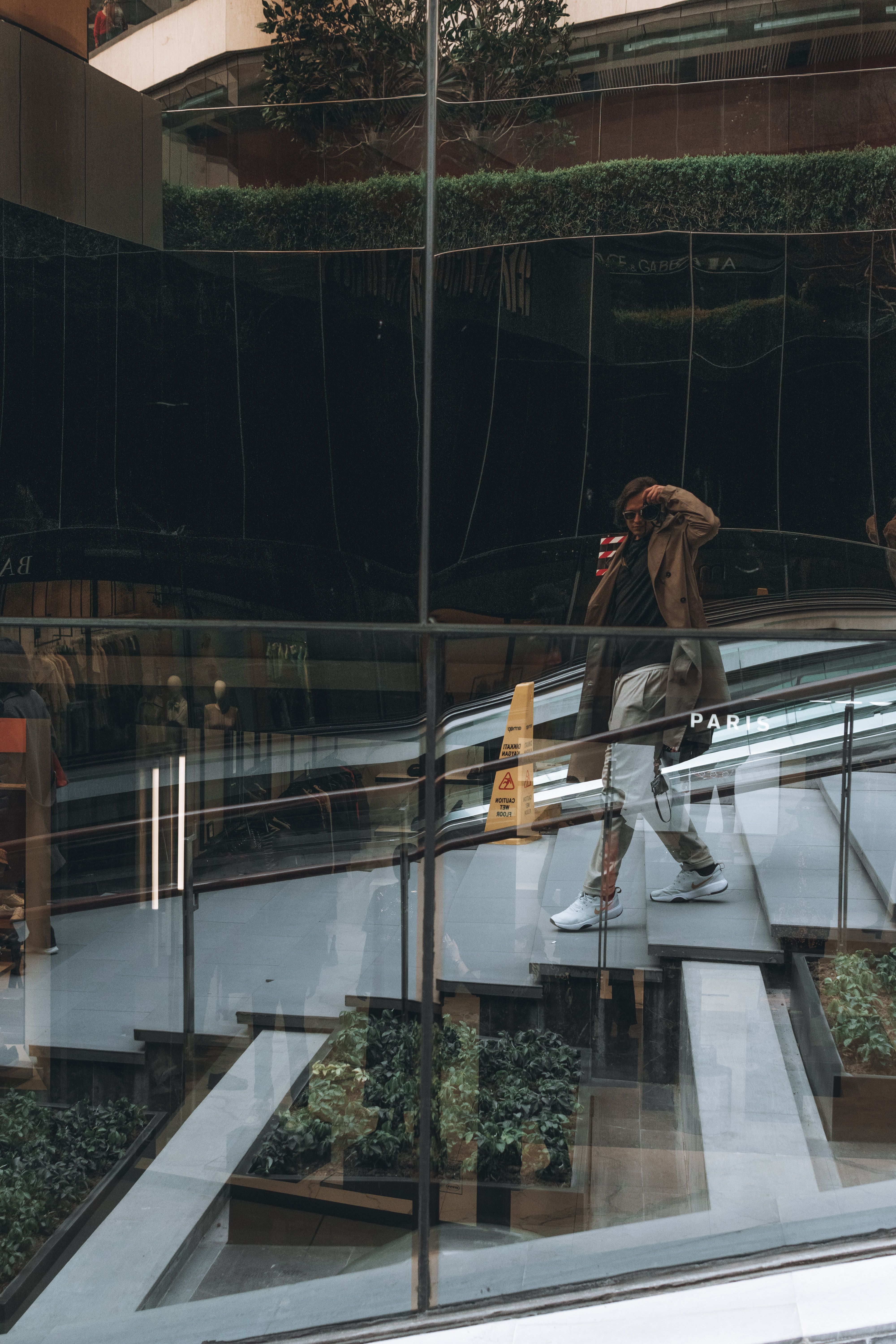 Man Walking on Stairs and Taking Pictures in Windows · Free Stock Photo