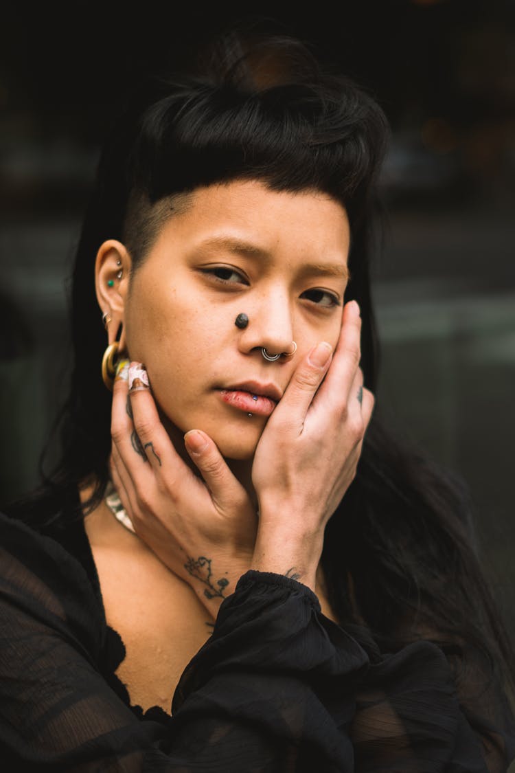 Portrait Of A Brunette Woman With A Fringe, Piercing And Beauty Mark