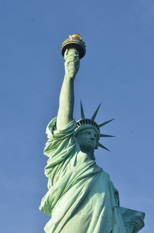 Free Captivating view of the Statue of Liberty in New York City, highlighting its grandeur against a clear blue sky. Stock Photo