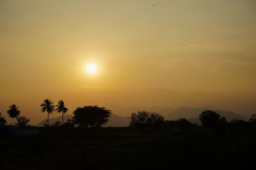 Golden sunset over trees and mountains in Krishnankovil, India., free online jigsaw puzzle on JigsawPuzzlesFreeOnline.org