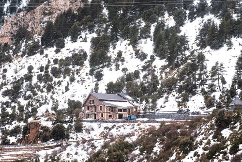 Free Charming mountain village covered in snow, nestled in Bouira, Algeria's scenic landscapes. Stock Photo