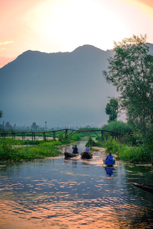 Men Sailing in Canoe Boats on River at Dawn
