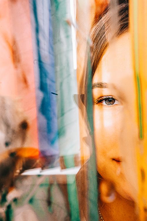 Free Artistic portrait of a woman with vibrant glass reflections enhancing a creative visual effect. Stock Photo