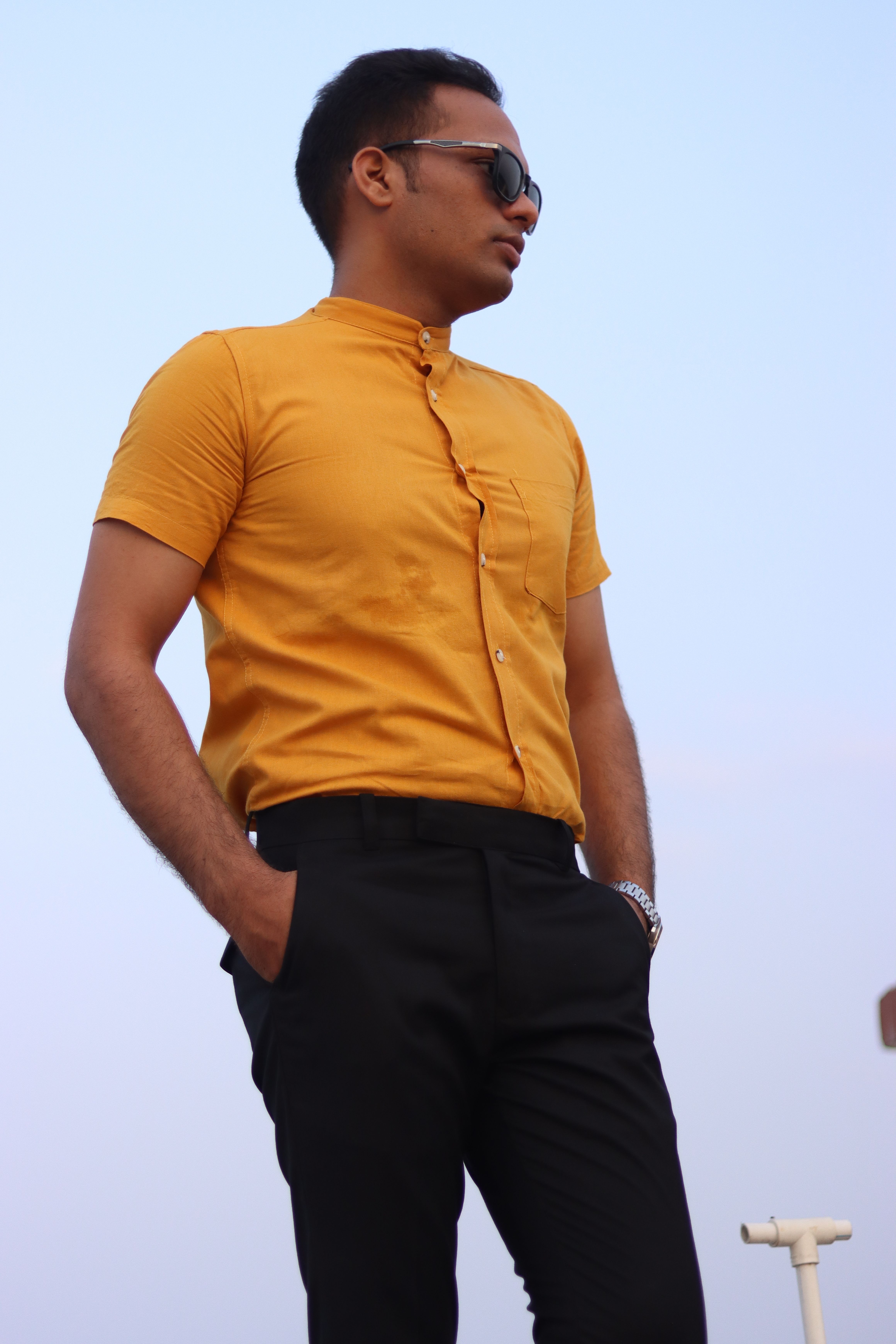 Man in Sunglasses Posing on Blue Sky Background · Free Stock Photo