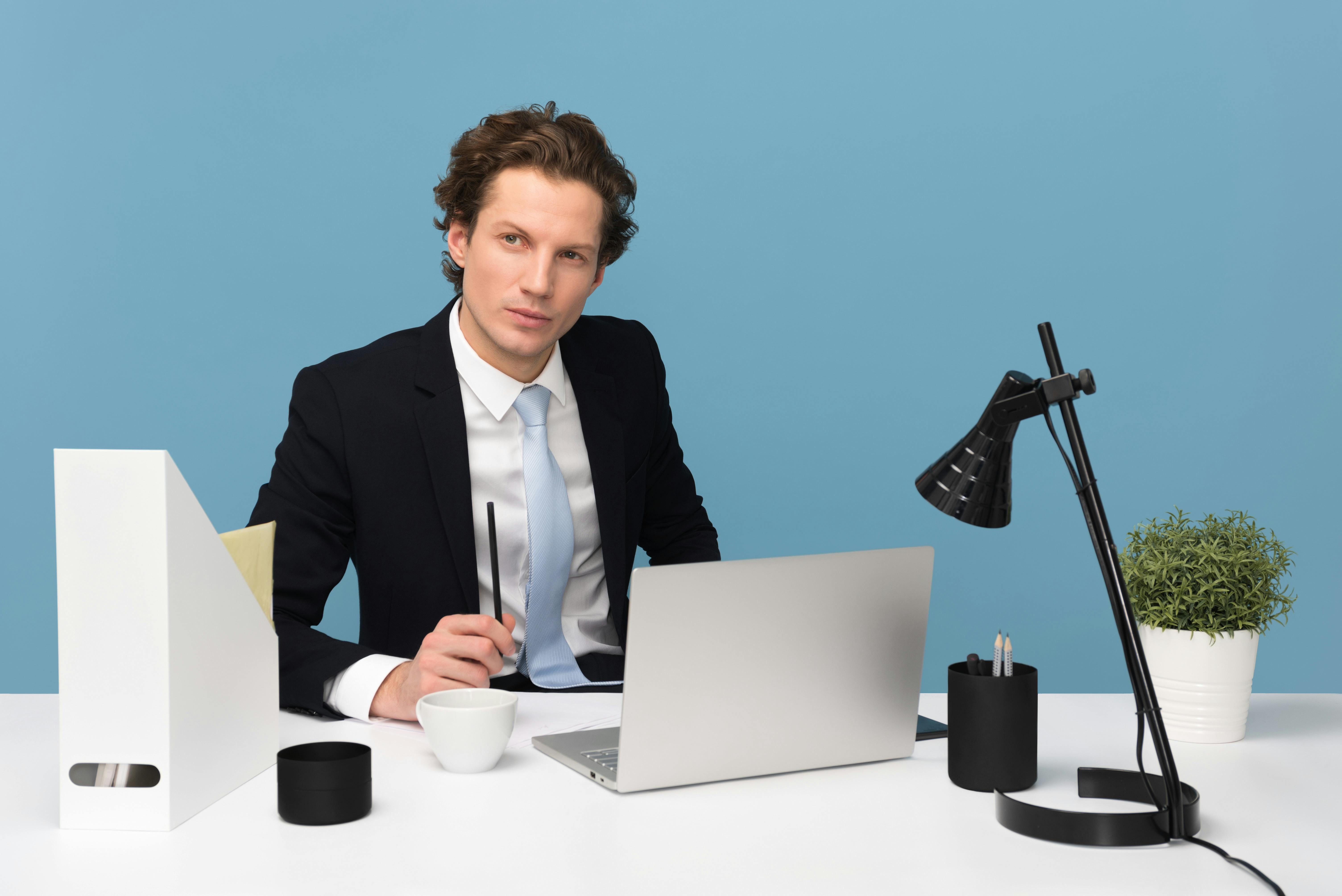 Man in black suit jacket in his office. | Photo: Pexels