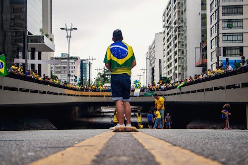 People with Brazilian Flags Gathering on Street above Underground Passageway