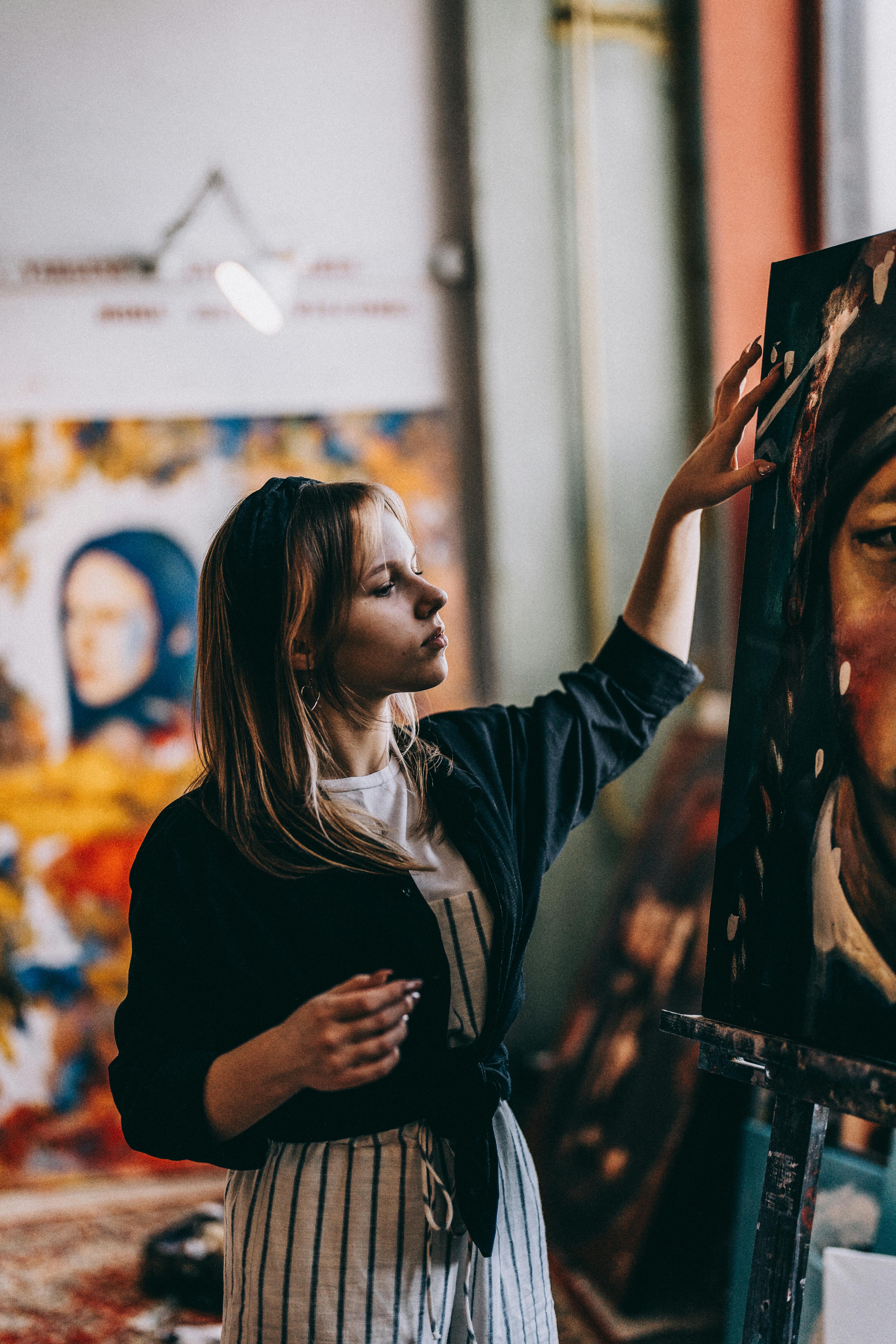 Girl Posing in Artists Studio with a Painting in Background  Free Stock  Photo