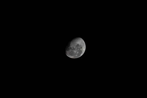 Free A clear view of the crescent moon in a starless night sky, showcasing lunar details. Stock Photo