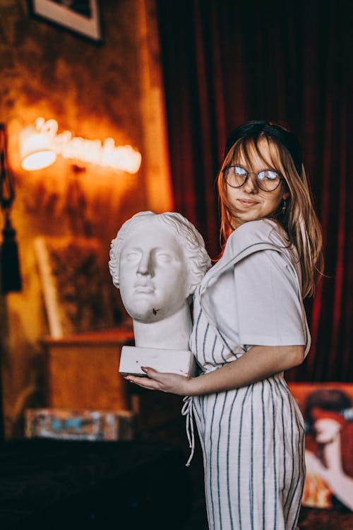 A Teenager Holding a Bust