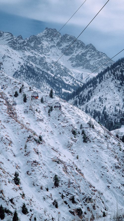 Free Breathtaking winter scenery with snow-covered mountains and cable cars in Almaty, Kazakhstan. Stock Photo