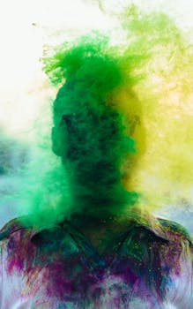A vibrant portrait of a person celebrating Holi with a cloud of colorful powder engulfing their face.