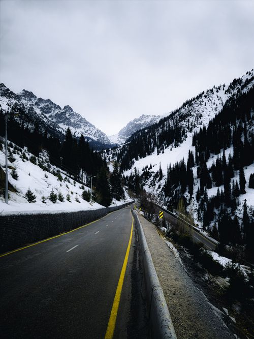 Free Captivating view of a road winding through snowy mountains in Almaty, Kazakhstan. Stock Photo