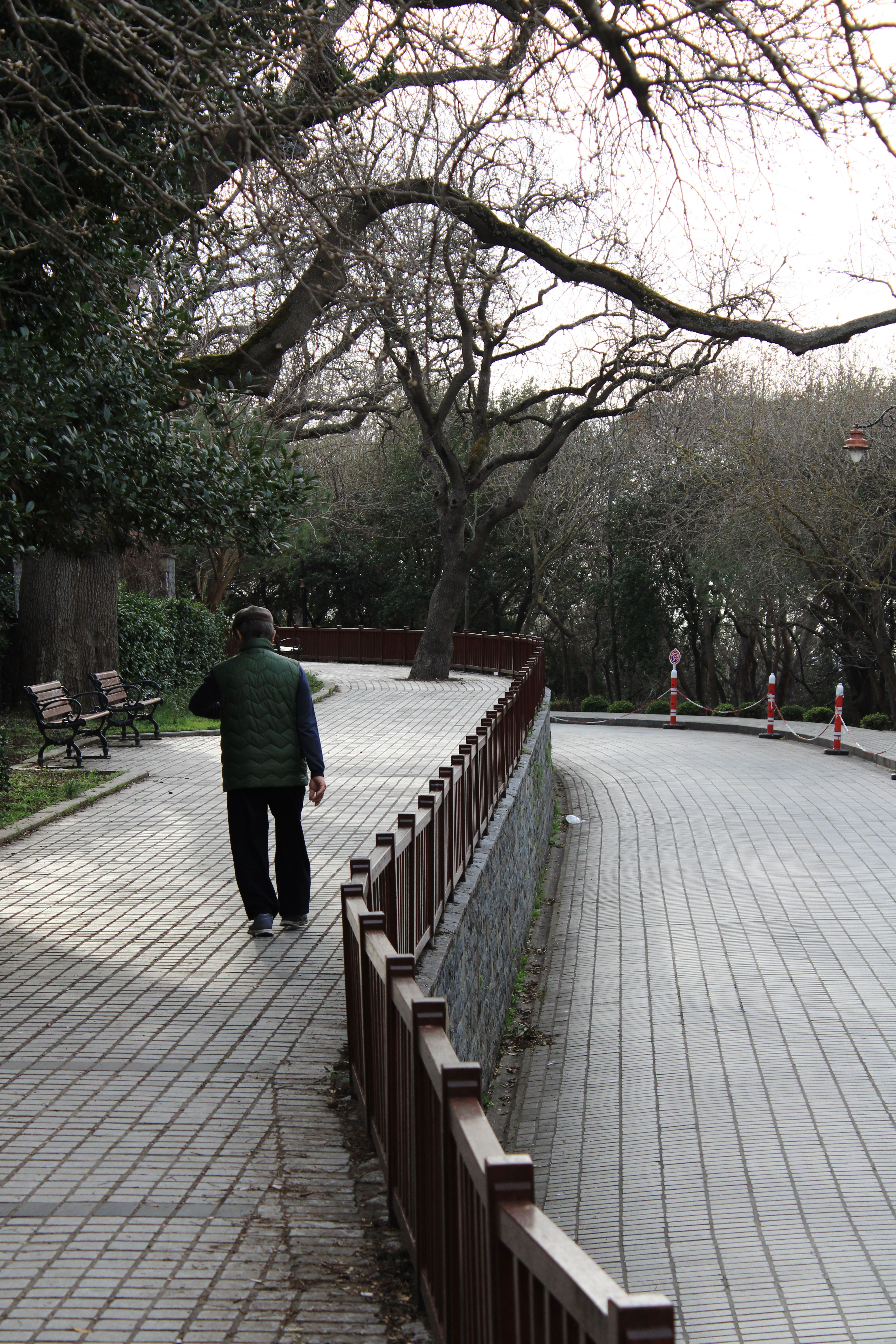 Man Walking next to Railing · Free Stock Photo