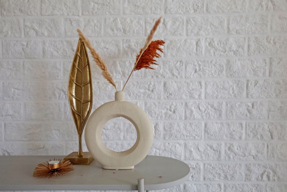 modern bookshelf accessories including ceramic vases and sculptural objects - modern bookshelf decor