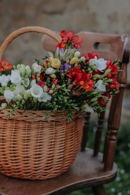 A colorful freesia bouquet arranged in a wicker basket, exuding summer vibes.