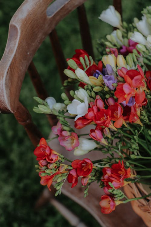 Bunch of Flowers on Wooden Chair