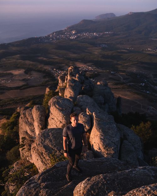 Free Explore breathtaking mountain views with a lone hiker at sunset. Stock Photo