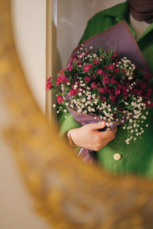 Woman Holding Bouquet of Tiny Flowers