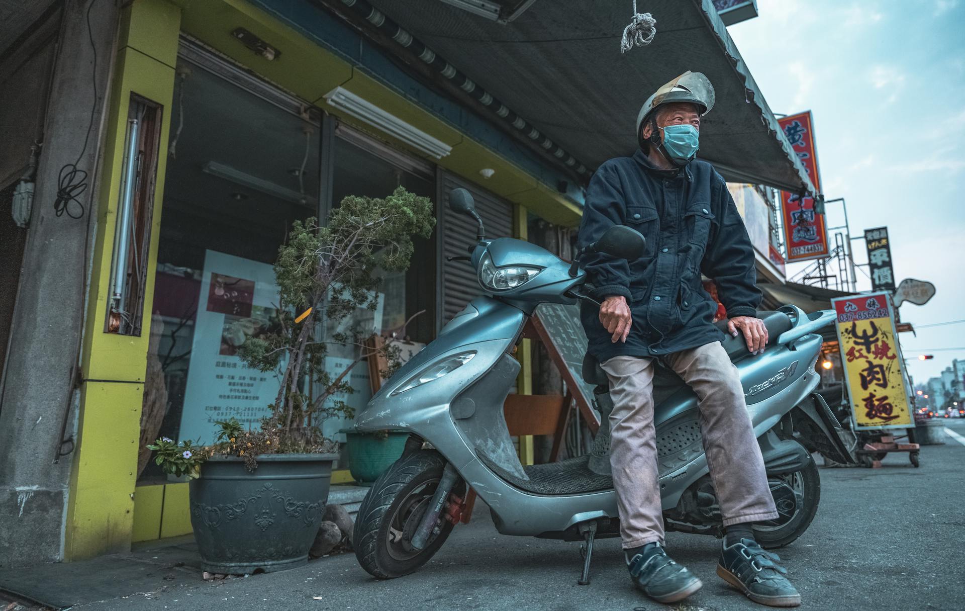 Man Standing by Scooter