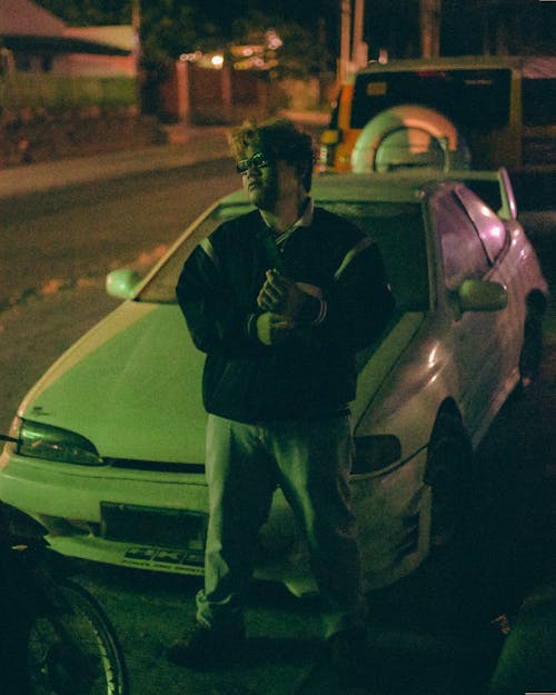 Man Standing by White Car