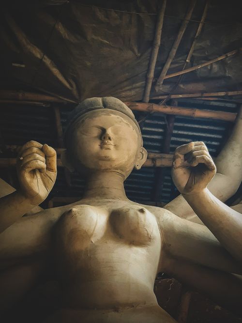 Free Clay sculpture of Goddess Durga being crafted in a Kolkata workshop, showcasing cultural artistry. Stock Photo