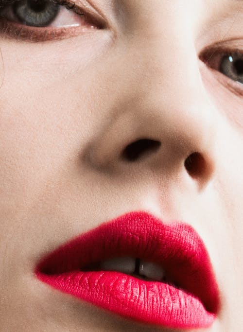 Close-up of the Face of a Woman Wearing Pink Lipstick 