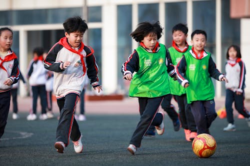 Kids Playing in a Football Match 