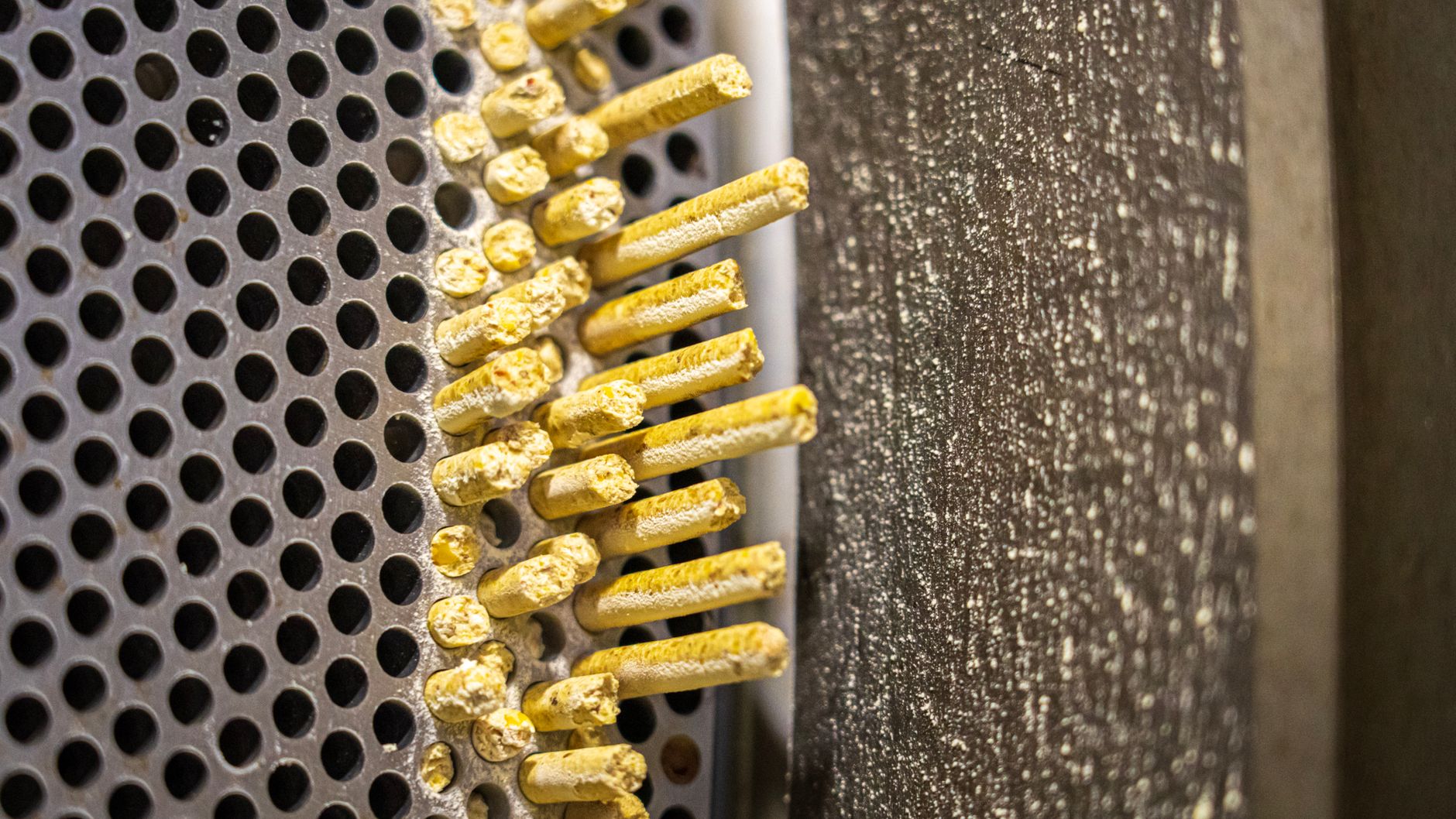 Detailed view of an industrial grinder's metal surface and grating.
