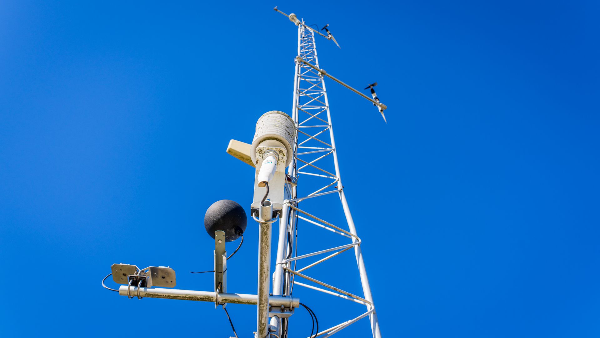 Low Angle Shot of a Transmission Tower on the Background of a Blue Sky