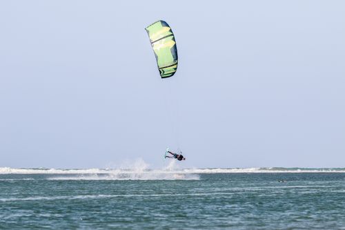 Free Exciting kitesurfing action with a vibrant kite over ocean waves, showcasing extreme sports adventure. Stock Photo