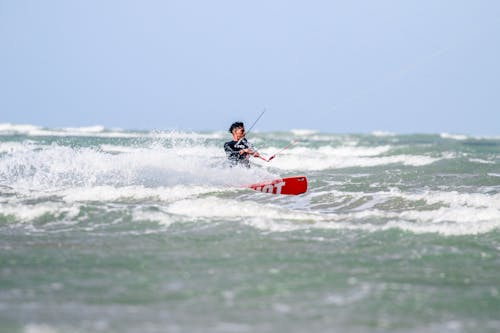 Man Kitesurfing in a Wavy Sea 