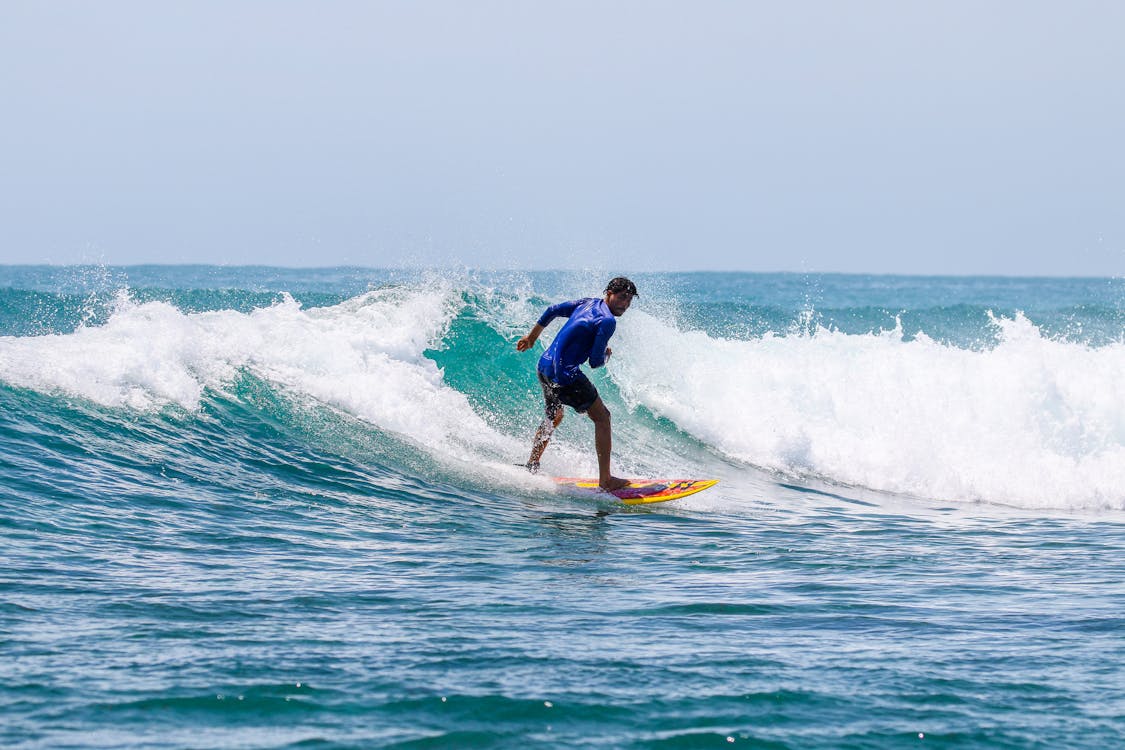 A Man Surfing on a Big Wave 