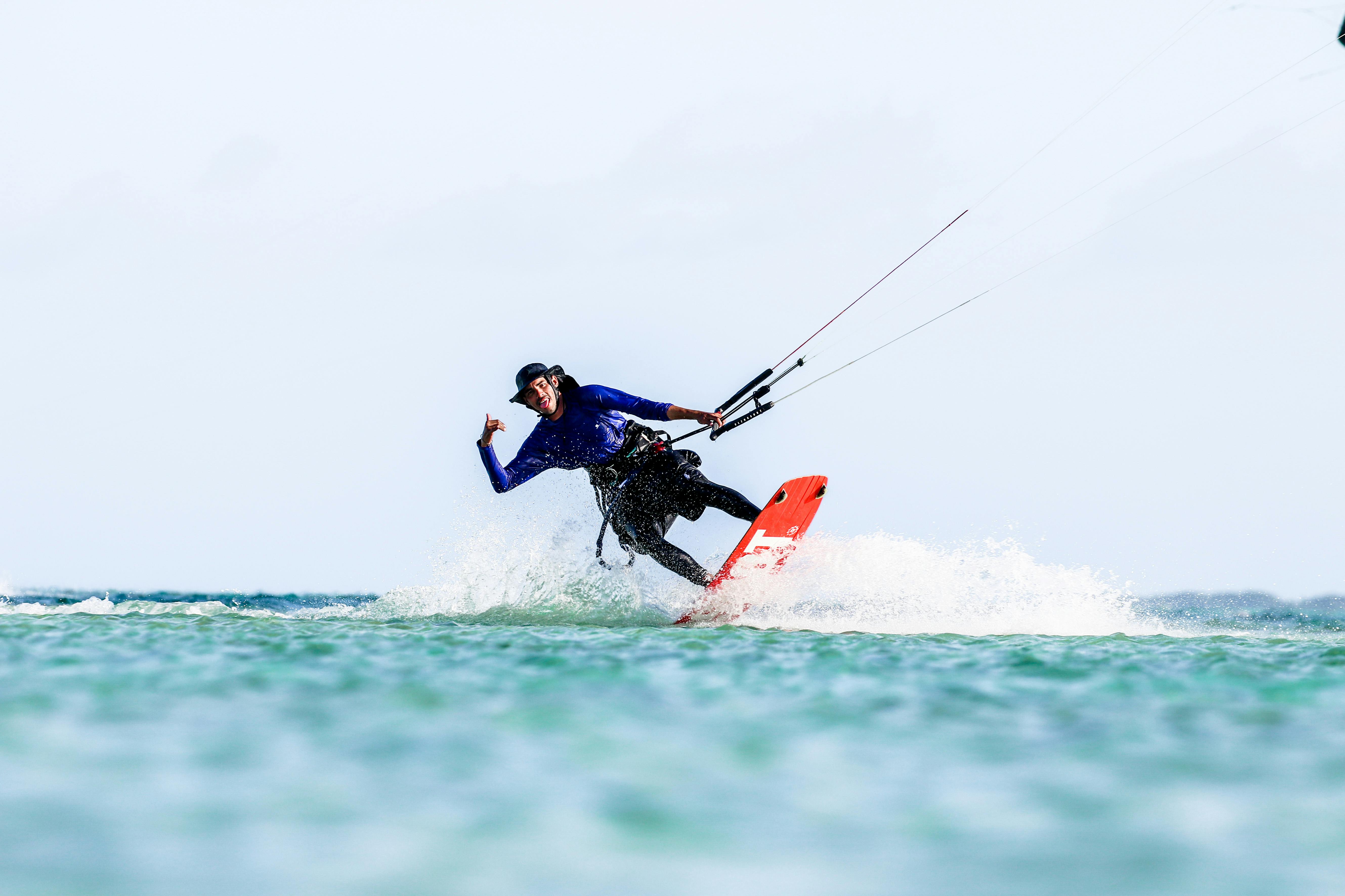 A thrill-seeker kitesurfing on the open ocean, showcasing skills and joy.